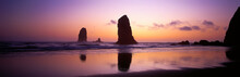 Panoramic Landscape. Dramatic And Colorful Sunset Sky Over Pacific Ocean At Haystack Rocks On Cannon Beach In Oregon. Panorama Of Sunset On The Beach With Sea Rocks And Cloudy Skies.