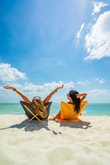 Sticker - Woman enjoying her holidays on a transat at the tropical beach