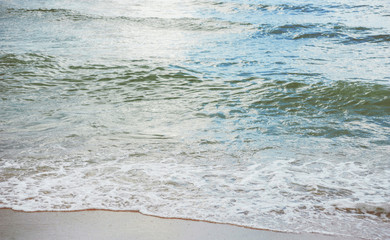 Beach, sand, water. .Photo of a little wave on beach sand