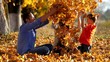 © MEDIAIMAG - Happy family joy and fun in nature playing with autumn leaves, slow motion
