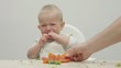 © MEDIAIMAG - Baby cry in baby chair, mother hand offer food, difficult  food diversification