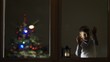 © MEDIAIMAG - Funny child look careful on window in the night for Santa Claus coming, Christmas tree, waiting big celebration, conceptual