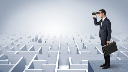 Wall Mural - businessman standing on maze and looking forward to the future concept