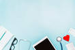 Background on medicine with stethoscope, medicine, tablet and notepad