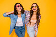 © deagreez - Portrait beautiful cute charming teen teenagers satisfied content chill laughter touch hair free time weekends summer travel holidays spring dressed checked shirt denim isolated yellow background