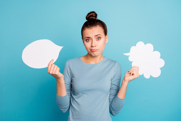 Wall Mural - Portrait of her she nice attractive lovely doubtful girl holding in hands two boards copy empty blank space isolated over bright vivid shine turquoise background