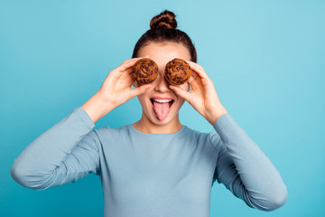 Close up photo beautiful she her lady hide eyes advising buy buyer try new yummy just baked tasty cacao color muffins tongue out mouth wear casual sweater pullover isolated blue bright background