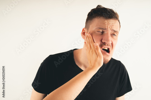 Cuadros en Lienzo Emotional male getting slapped in face while shouting with closed eyes in fear o