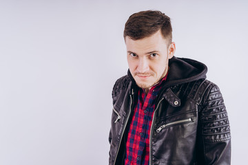 Wall Mural - Man in trendy jacket on white background Portrait of young male in leather jacket zipping up and smiling at camera on white background