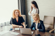 © alfa27 - Three focused caucasian young business women with different hairstyle working together, brainstorming in office.