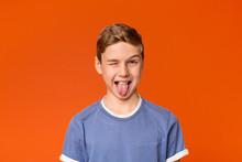 Playful Teen Boy Winking And Sticking Out Tongue