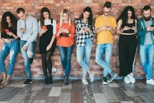 Always connected. Social networking. Group of millennials with smartphones surfing, chatting. Digital communication.