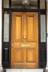 Wall Mural - Wooden Entrance Door to residential building in London. Typical door in the English style.