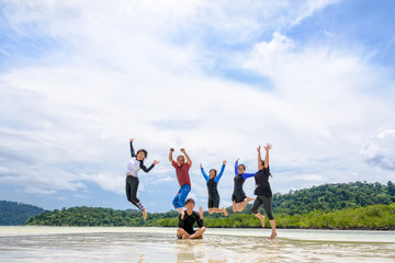 Wall Mural - Happy family jumping together on the beach, Thailand