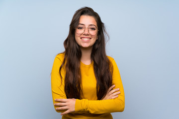 teenager girl over isolated blue wall laughing