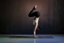 Woman Practicing Yoga, Adho Mukha Vrksasana Exercise, Downward Facing Tree Pose