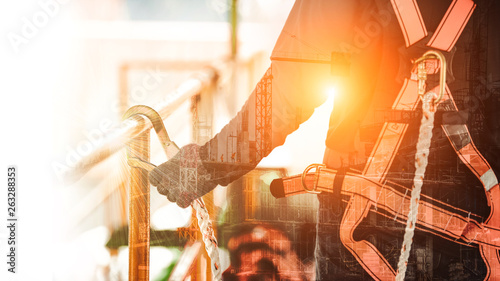 Fotomural Double exposure of Construction worker wearing safety harness and safety line wo