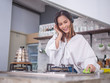 © Sataporn - young happy asia housewife enjoy with her cleaning work at home or her coffee cafe