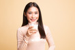 © halfbottle - Healthy Asian woman drinking a glass of milk.