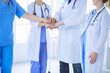 © lenets_tan - Group of doctors putting their hands together. Close-up