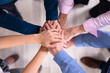 © Andrey Popov - Businesspeople Stacking Hands Over Each Other