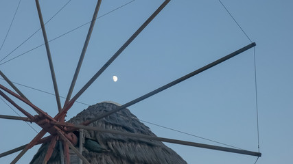 Wall Mural - the moon and a close up of the historic windmills on mykonos