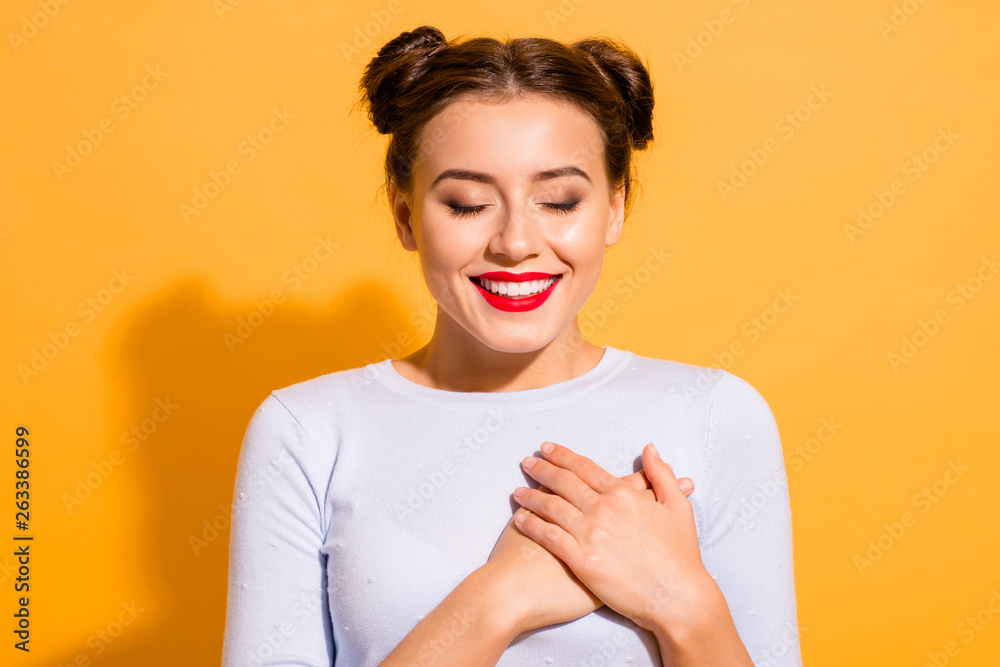 Close-up portrait of her she nice-looking attractive lovely peaceful sweet winsome cheerful glamorous girl touching heart meditating isolated over bright vivid shine yellow background - obrazy, fototapety, plakaty 