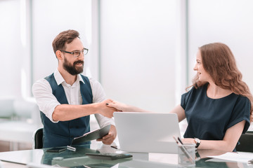 business colleagues shaking hands over the Desk