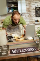 Wall Mural - Man cooking using tablet