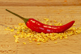 Fototapeta  - Chili pepper on-top of a pile of chili seeds