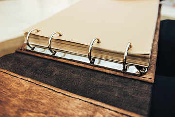 Wall Mural - An open book of wood and leather. ring notebook mechanism.