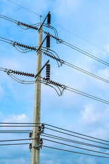 High voltage electricity pole on bright sky clouds background, Electricity pole against blue sky clouds, Power distribution