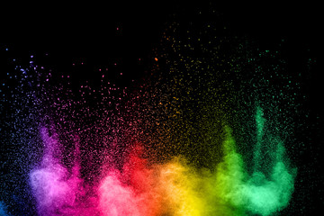 Wall Mural - Launched colorful powder on black background.Color powder explosion.Colorful dust splashing.