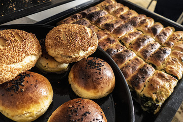 Wall Mural - homemade pastries, spinach pie, sesame buns and bagels, Turkish style dough food,