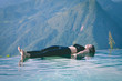 © 220 Selfmade studio - Beautiful Attractive Asian woman practice yoga Dead Body or Savasana on the pool above the Mountain peak in the morning in front of beautiful nature views in SAPA vietnam,Feel so comfortable