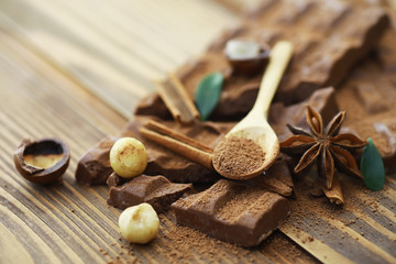 A bar of milk chocolate on the table. Chocolate with nuts and cinnamon.