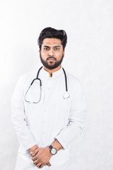 Canvas Print - Handsome young doctor in a white coat with a stethoscope. Health care concept.