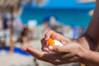 Man hand apply sunscreen on the beach