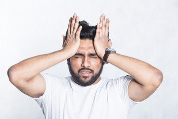 Sticker - Young man experiencing head hurts, looking miserable and exhausted.