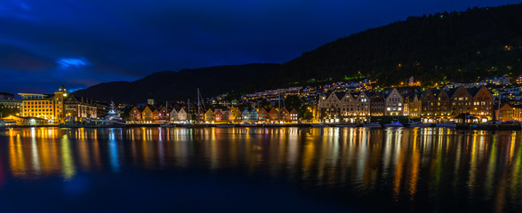 Wall Mural - Wide night cityscape of the iconic Bergen harbour ad Bryggen historic district, Norway