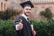 © Тарас Нагирняк - Young handsome graduated man holding degree , doing ok sign with fingers, excellent symbol!