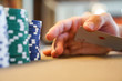 © Nicholas - secretly palming a playing card at the poker table with poker chips at a vegas casino