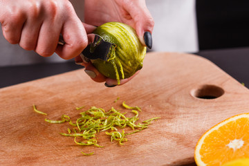 young woman in a gray aprons cut cedar lime