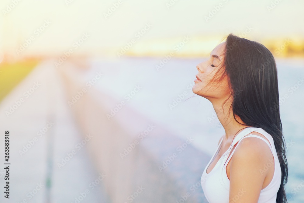 Side view profile portrait of a happy brunette woman relaxing breathing fresh air outdoors in summer Girl close eyes doing deep breath exercises. Positive emotion success, peace of mind, zen concept. - obrazy, fototapety, plakaty 