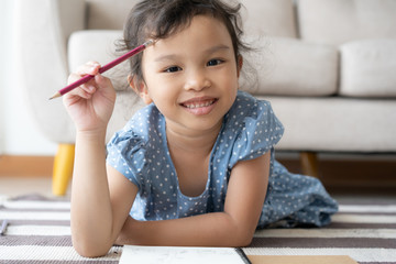  portrait a little cute girl is studying the new lesson, smile, cheerful