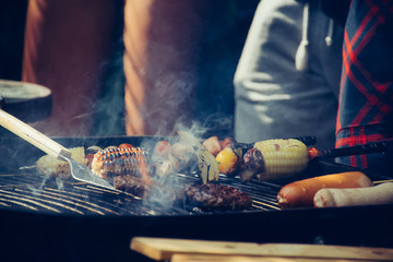 barbecue  and party.Close up of a man making barbecue for party with friends outdoors. 