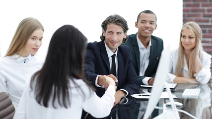 Wall Mural - handshake business women with business partner at the negotiating table