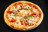 Fototapeta  - seafood pizza on the black background