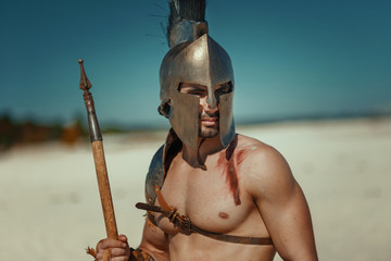 Wall Mural - Male athlete in the armor of an ancient warrior