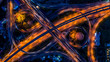 © Kalyakan - Road interchange in the city at night with vehicle car light movement, Aerial view.